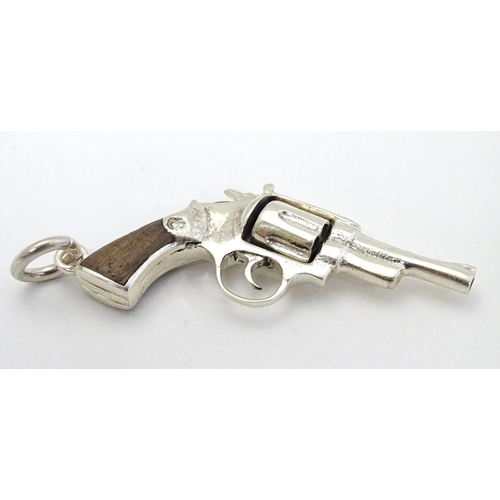 415 - A pendant formed as a hand gun / revolver. 21stC .  2 1/4'' long