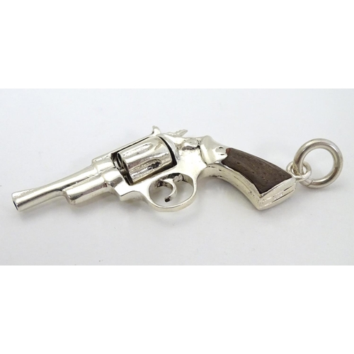 415 - A pendant formed as a hand gun / revolver. 21stC .  2 1/4'' long