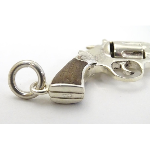 415 - A pendant formed as a hand gun / revolver. 21stC .  2 1/4'' long