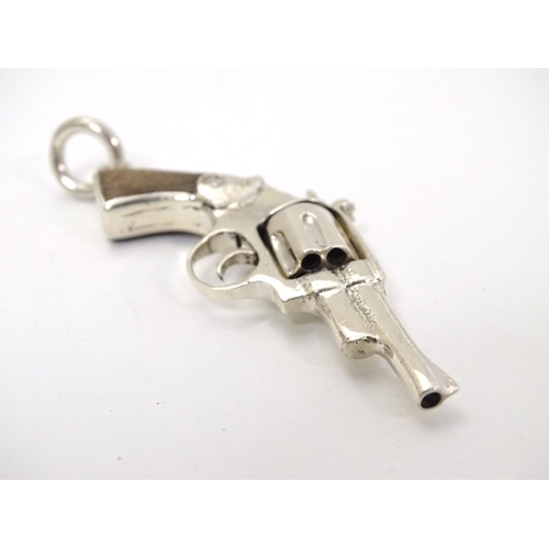 415 - A pendant formed as a hand gun / revolver. 21stC .  2 1/4'' long