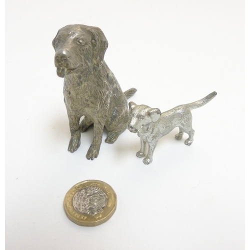 455 - A cast silver plate model of a dog standing together with another, formed as a seated dog. The  larg... 