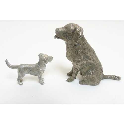 455 - A cast silver plate model of a dog standing together with another, formed as a seated dog. The  larg... 