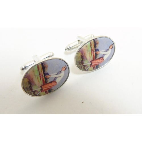 456 - A pair of cufflinks having oval cabochon with golfer decoration