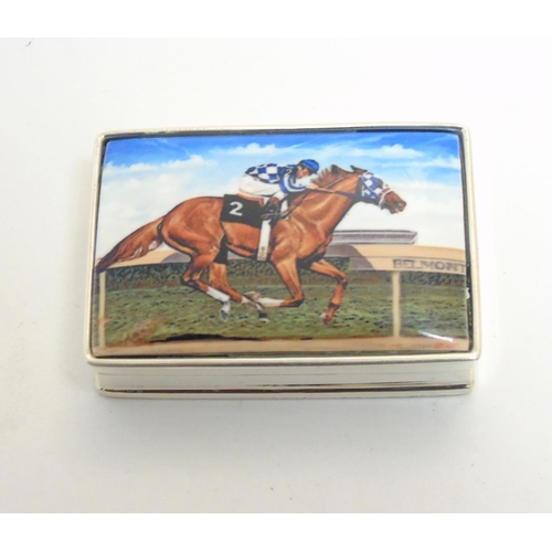 457 - A pill box with enamel decoration to lid, depicting racehorse and jockey. Approx 1 3/4'' x 1 1/4'' x... 