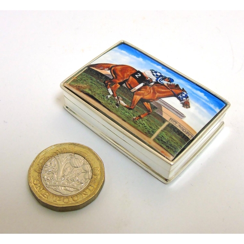 457 - A pill box with enamel decoration to lid, depicting racehorse and jockey. Approx 1 3/4'' x 1 1/4'' x... 