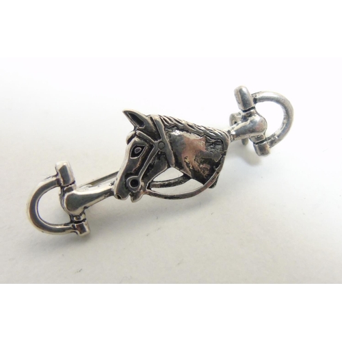 471 - A brooch formed as a horses bit with horse head decoration to centre, approximately 1 1/2'' wide