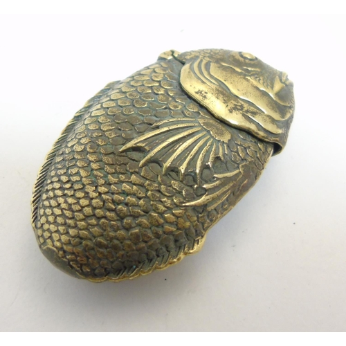 473 - A brass vesta case formed as a fish. Approx 2 1/2'' long