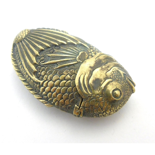 473 - A brass vesta case formed as a fish. Approx 2 1/2'' long