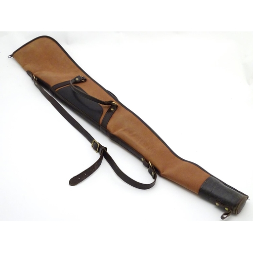 491 - Shooting: A Brady-type canvas and leather gunslip with wool lining, having shoulder strap and reinfo... 