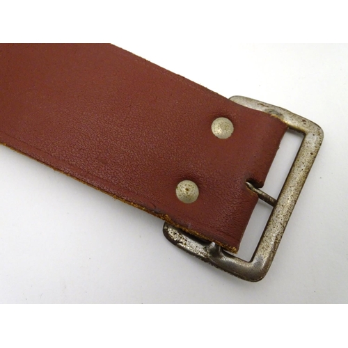 503 - Shooting: A vintage brown leather 12 bore cartridge belt, with brass buckle and open-loop provision ... 