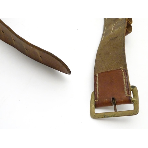 503 - Shooting: A vintage brown leather 12 bore cartridge belt, with brass buckle and open-loop provision ... 