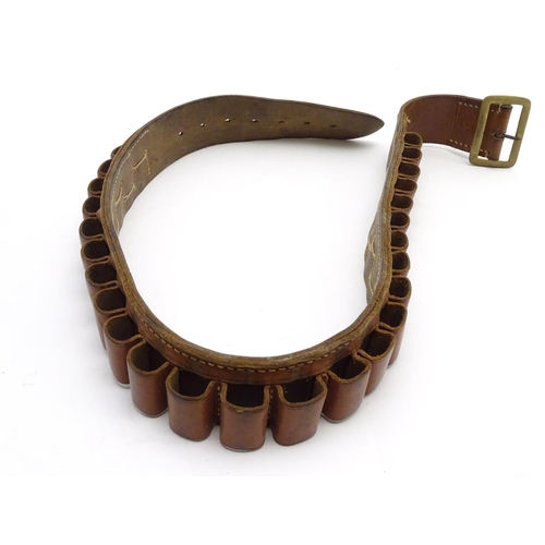 503 - Shooting: A vintage brown leather 12 bore cartridge belt, with brass buckle and open-loop provision ... 