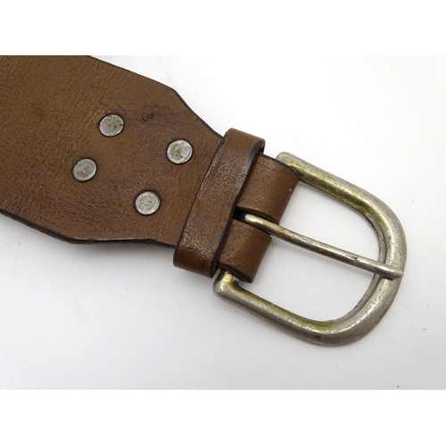 503 - Shooting: A vintage brown leather 12 bore cartridge belt, with brass buckle and open-loop provision ... 