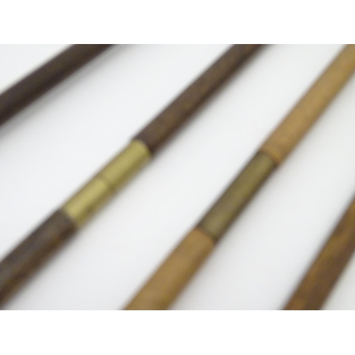 511 - Shooting: A collection of four antique shotgun cleaning rods, comprising a one-piece beech example w... 