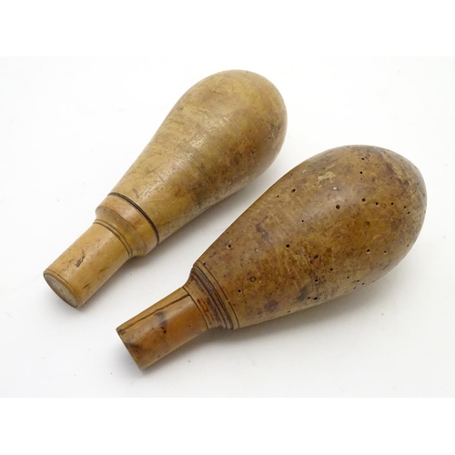 519 - Shooting: Two 18thC Continental turned wooden powder flasks, of boxwood construction, each of bulbou... 