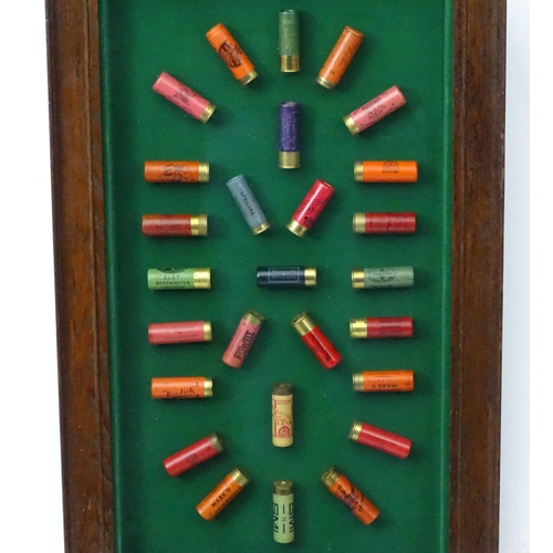 526 - Cartridge display board: A 20thC shotgun cartridge display case, the baize lined shadow box with oak... 