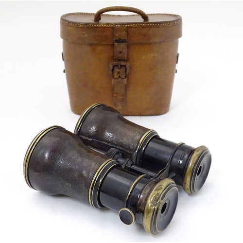 529 - A cased pair of WWI-era French multi-use binoculars, of brass construction with black finish and lea... 