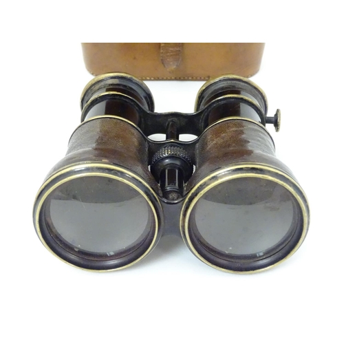 529 - A cased pair of WWI-era French multi-use binoculars, of brass construction with black finish and lea... 