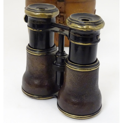 529 - A cased pair of WWI-era French multi-use binoculars, of brass construction with black finish and lea... 