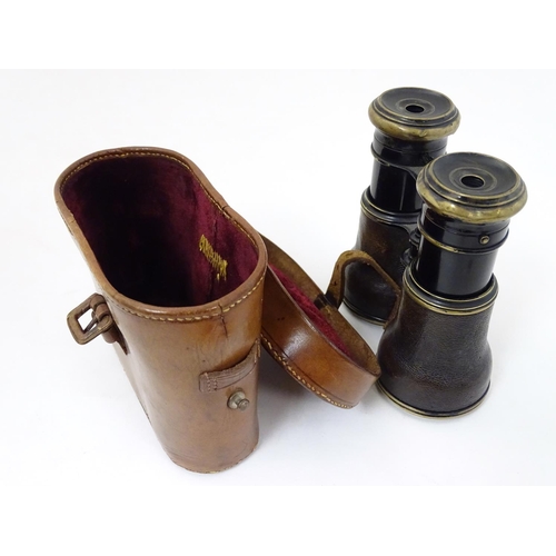 529 - A cased pair of WWI-era French multi-use binoculars, of brass construction with black finish and lea... 