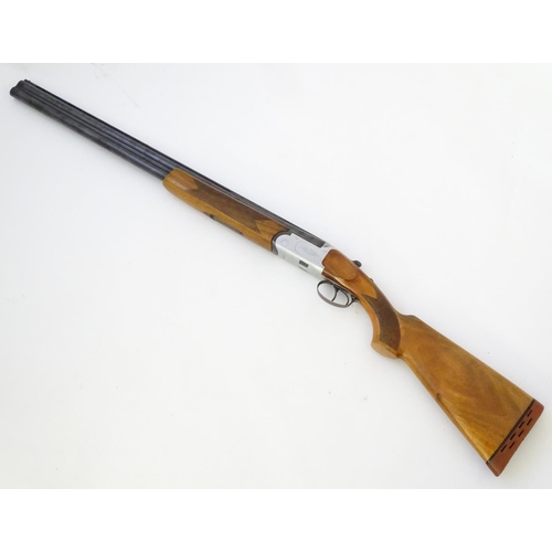 606 - Shotgun: A 12 bore over and under boxlock shotgun by FIAS, Italy for Gower Ltd. 28'' fixed choke bar... 