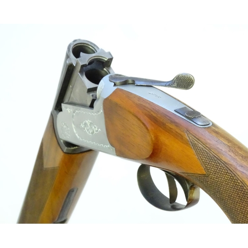 606 - Shotgun: A 12 bore over and under boxlock shotgun by FIAS, Italy for Gower Ltd. 28'' fixed choke bar... 