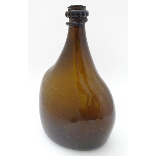 100 - An 18thC Georgian brown glass large bottle with applied top and kick-up under, 12 1/2'' high.