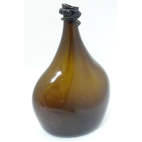 100 - An 18thC Georgian brown glass large bottle with applied top and kick-up under, 12 1/2'' high.