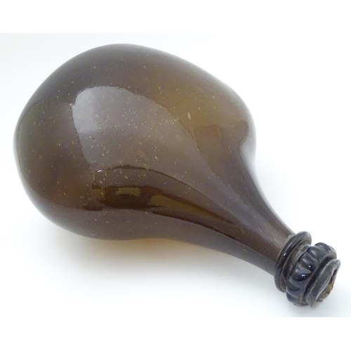 100 - An 18thC Georgian brown glass large bottle with applied top and kick-up under, 12 1/2'' high.