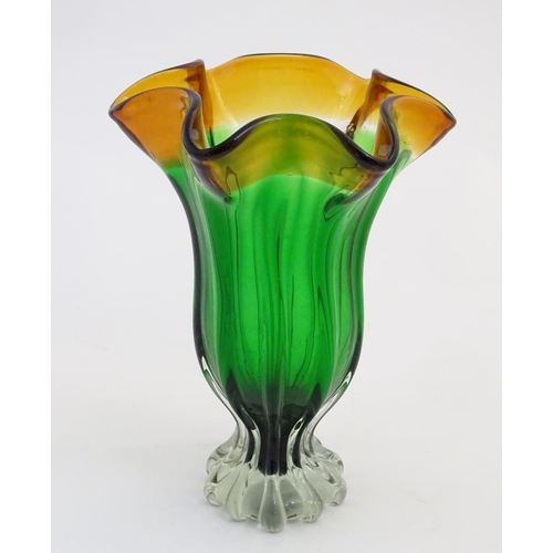 102 - Glass : a mid 20thC Studio glass vase with fluted wavy rim, green body, clear foot and Amber top, ha... 