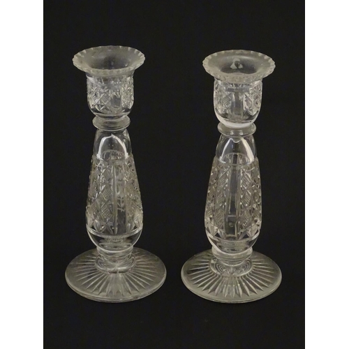 111 - Glass : a pair of cut glass candlesticks with hobnail like decoration and star cut decoration to und... 