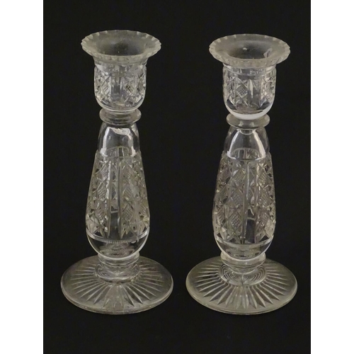 111 - Glass : a pair of cut glass candlesticks with hobnail like decoration and star cut decoration to und... 