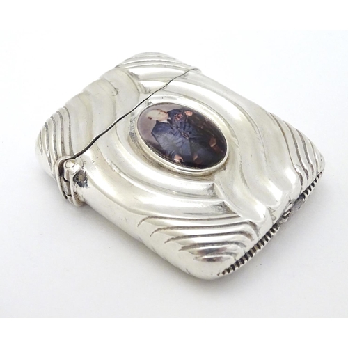 128 - A silver vesta case converted to a lighter and with later applied cabochon depicting Winston Churchi... 