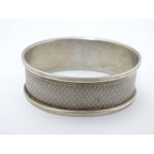 129 - A silver napkin ring Birmingham 1951 maker B & Co. Together with a thimble hallmarked Birmingham 192... 