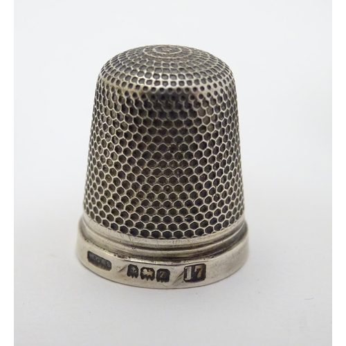 129 - A silver napkin ring Birmingham 1951 maker B & Co. Together with a thimble hallmarked Birmingham 192... 