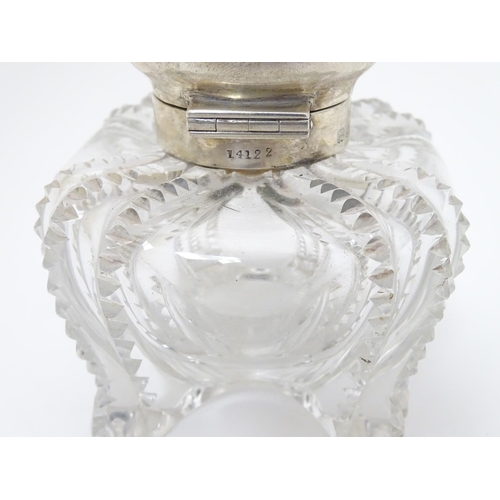 135 - A Victorian glass inkwell with silver top hallmarked London 1897 maker Hukin & Heath. Approx 3 1/2''... 