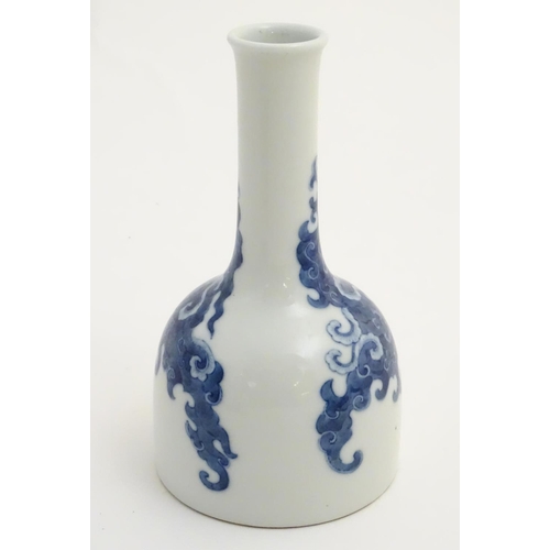 14 - A Chinese blue and white bottle vase with a stylised, scrolling cloud pattern. Character marks to ba... 