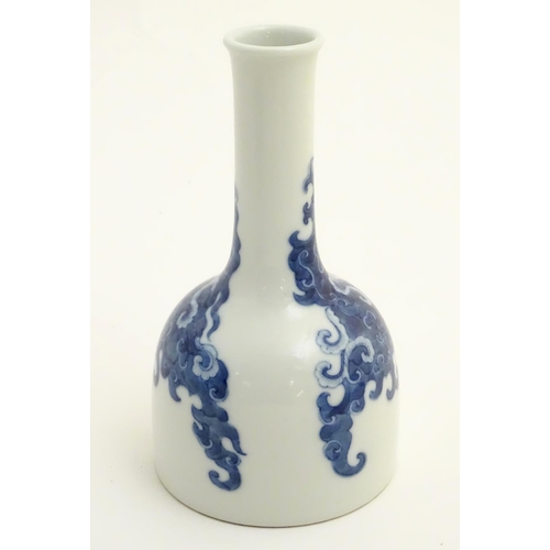 14 - A Chinese blue and white bottle vase with a stylised, scrolling cloud pattern. Character marks to ba... 