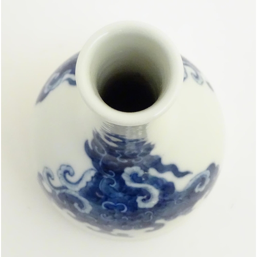 14 - A Chinese blue and white bottle vase with a stylised, scrolling cloud pattern. Character marks to ba... 