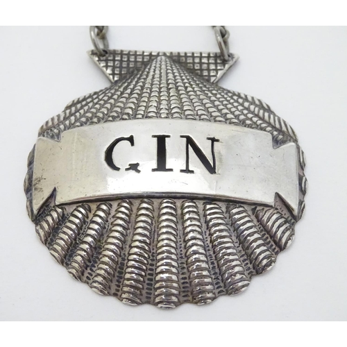 143 - Two silver plate decanter labels / bottle tags of scallop shell form 'Gin' and 'Port. ' 2'' wide