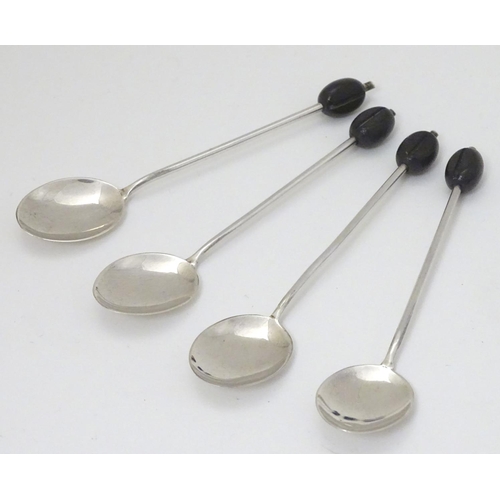 147 - 4 silver coffee spoons hallmarked Sheffield 1930 maker C W Fletcher & Son Ltd the handle surmounted ... 