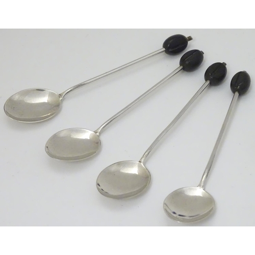 147 - 4 silver coffee spoons hallmarked Sheffield 1930 maker C W Fletcher & Son Ltd the handle surmounted ... 