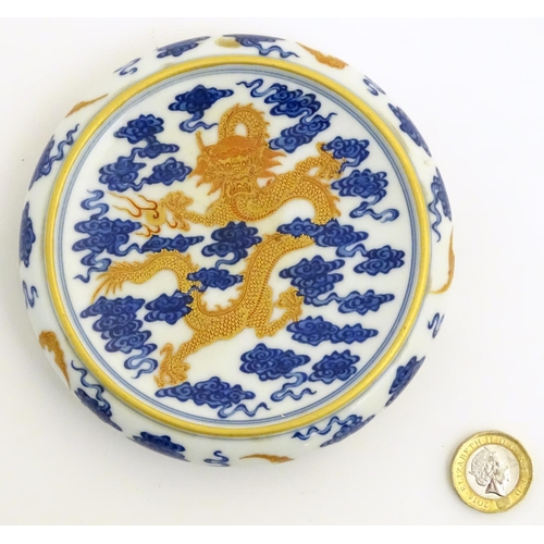 15 - A Chinese decorative stand for a vase/bowl, decorated with a dragon and stylised clouds. Raised on t... 