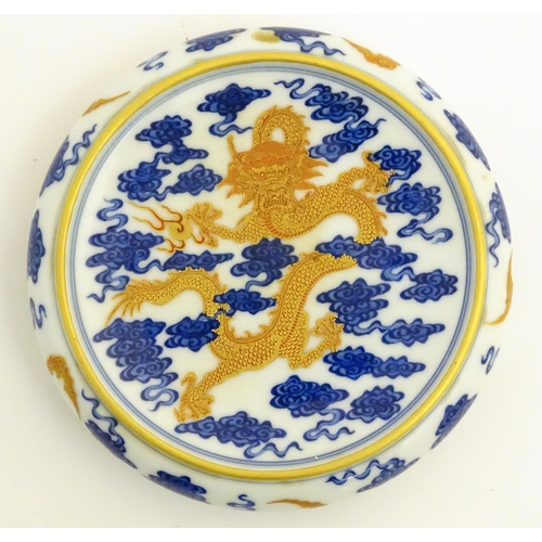 15 - A Chinese decorative stand for a vase/bowl, decorated with a dragon and stylised clouds. Raised on t... 