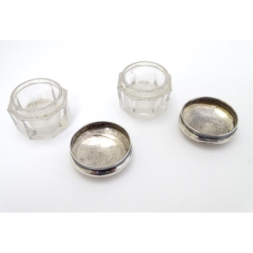 150 - A pair of glass pots with silver tops hallmarked Birmingham 1918 maker G & C Ltd. 1 1/4'' wide