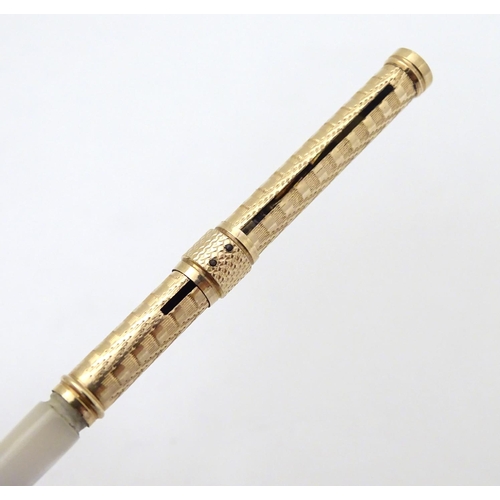 154 - A gilt metal dipping pen with mother of pearl handle. Cased 6 1/2'' long