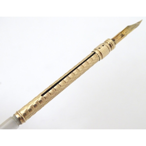 154 - A gilt metal dipping pen with mother of pearl handle. Cased 6 1/2'' long