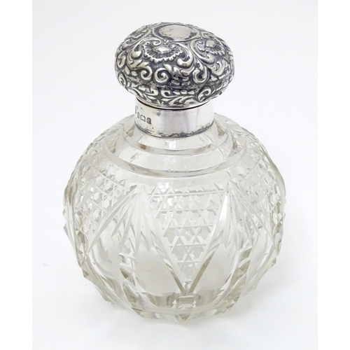 158 - A cut glass scent / perfume bottle with silver top hallmarked Birmingham 1904 4 1/2'' high overall