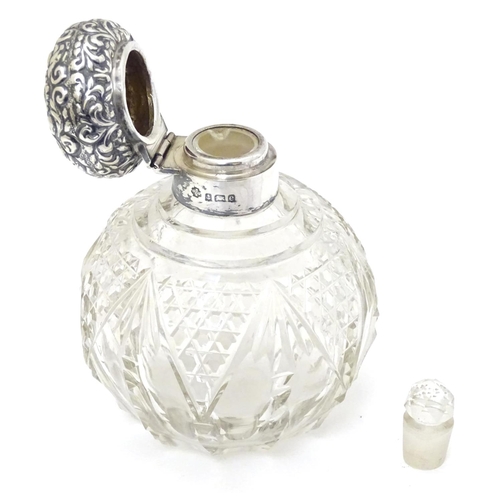 158 - A cut glass scent / perfume bottle with silver top hallmarked Birmingham 1904 4 1/2'' high overall