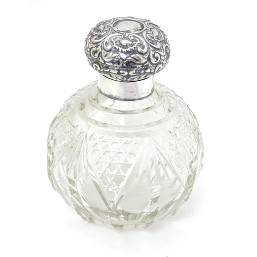 158 - A cut glass scent / perfume bottle with silver top hallmarked Birmingham 1904 4 1/2'' high overall